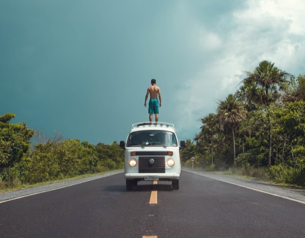 Henrique em cima da Kombi na estrada